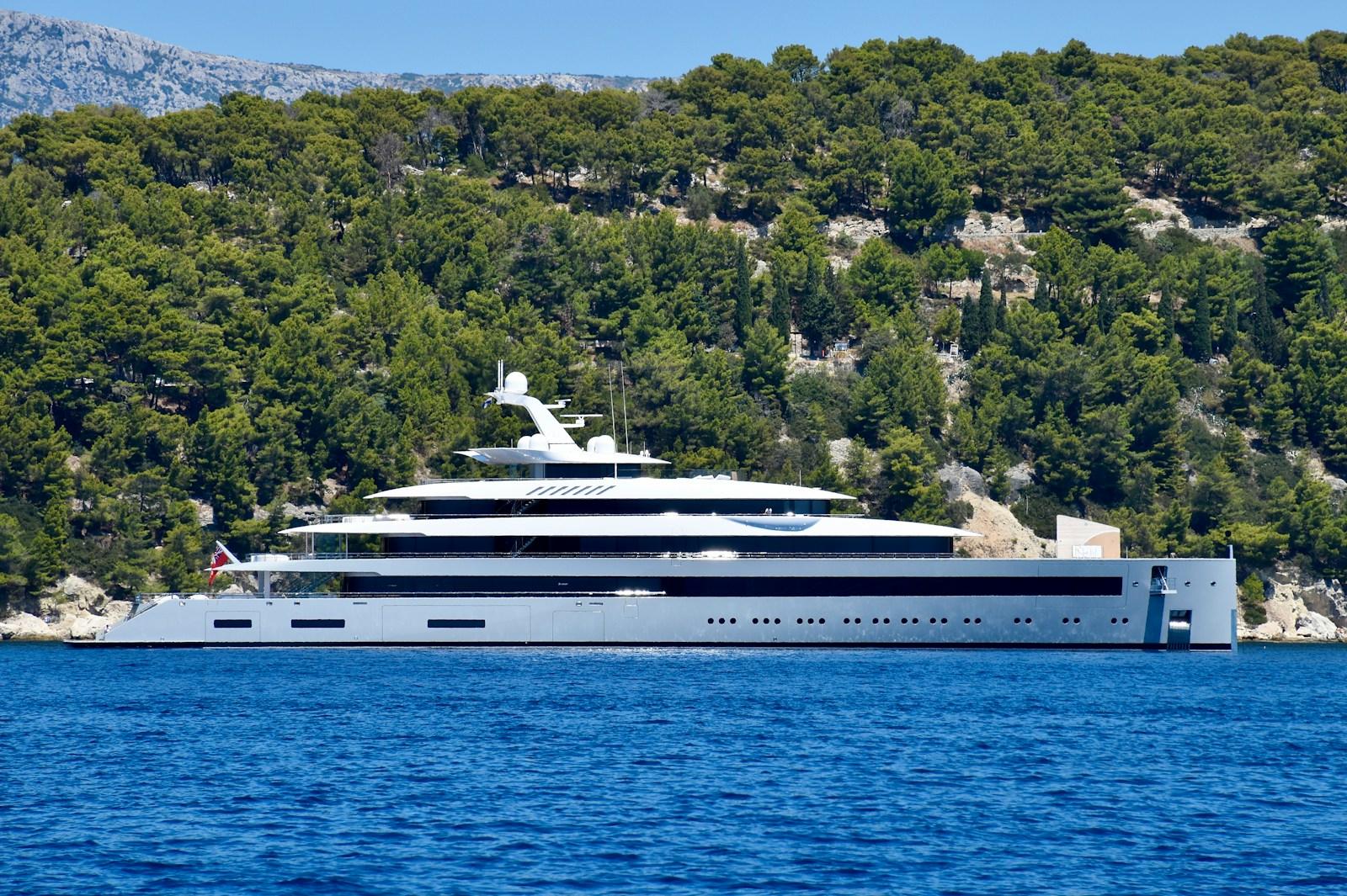 white cruise ship on sea near green trees during daytime